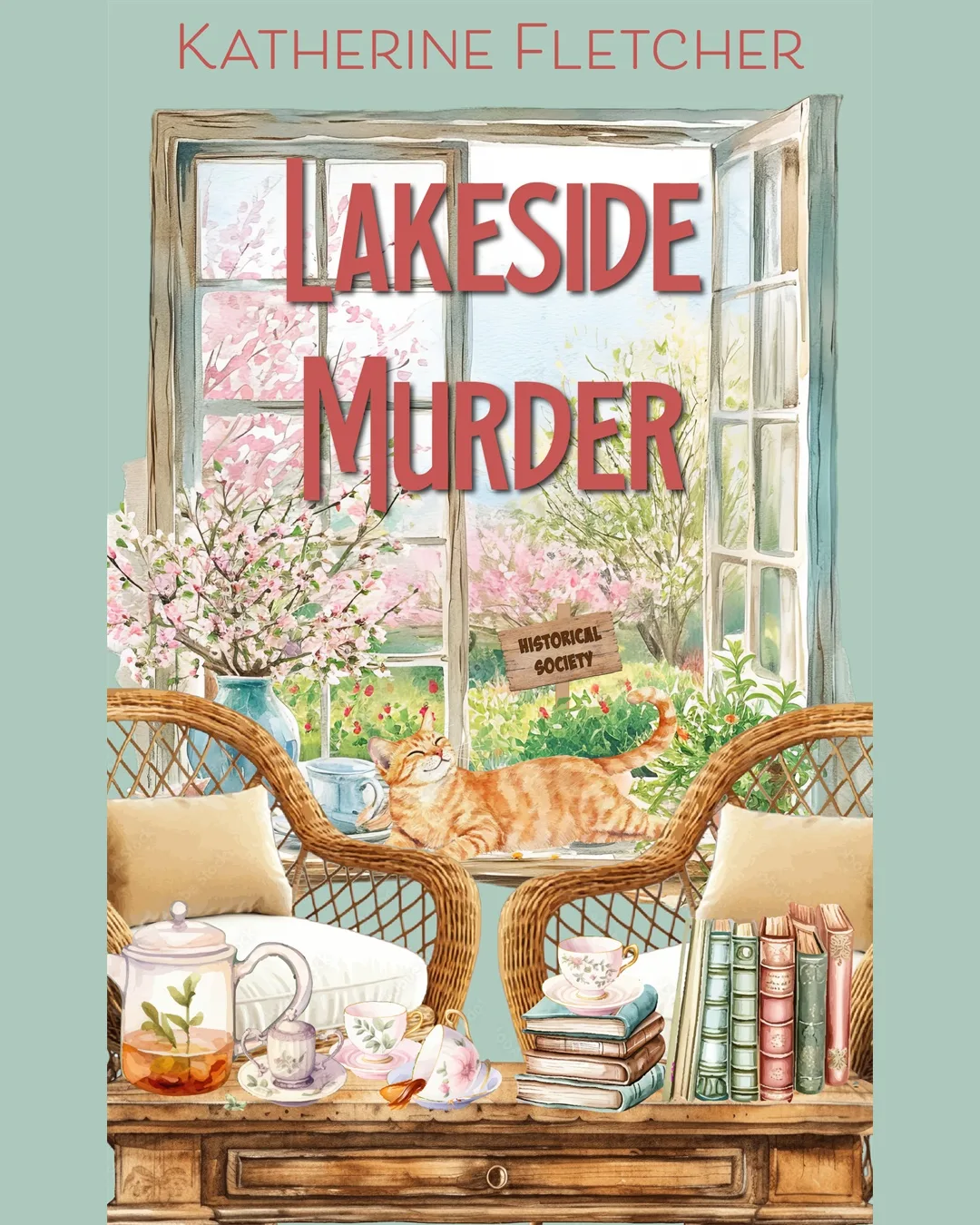 Lakeside Murder by Katherine Fletcher, with an orange cat, tea, books, and a window overlooking the Historical Society
